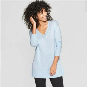 A new day light blue v-neck pullover sweater. Size S